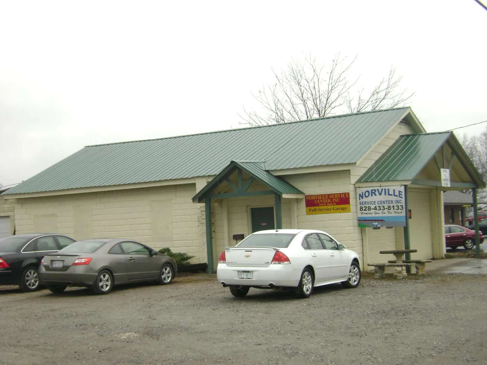 Green metal roof on a service garage with a covered entry in Woodstock